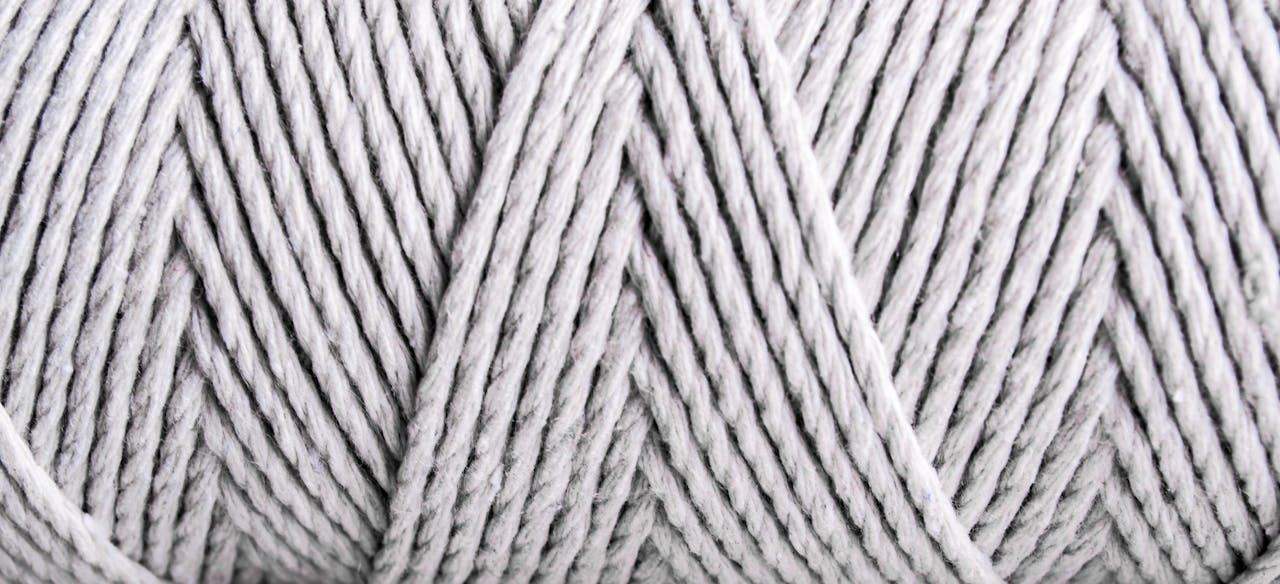 Detailed close-up of gray yarn fibers showcasing pattern and texture.